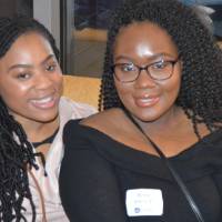 Two alumnae smile for a photo together at the Chicago Alumni Reception